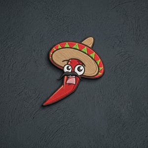 May include: An embroidered patch featuring a red chili pepper character with a black mustache and wide eyes, wearing a tan sombrero with a red and green patterned brim. The design is rendered in vibrant thread colors with a distinct black outline.