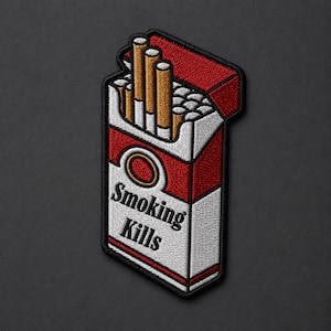 May include: An embroidered patch shaped like an open pack of cigarettes with a red and white design. The pack features three visible tan cigarettes at the top and the black text Smoking Kills printed on the front against a white background.