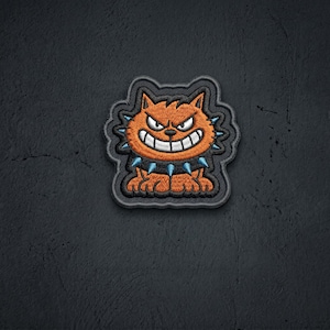 May include: An embroidered patch featuring an orange cat with a wide, toothy grin and narrowed eyes. The cat wears a black collar adorned with light blue spikes. The entire design is outlined in black thread with a thick, dark border.