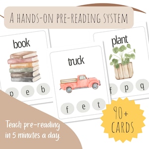 May include: Pre-reading flashcards with illustrations of a stack of books, a red truck, and a potted plant. The cards display the words "book", "truck", and "plant", alongside related letters. The image also includes the text "A HANDS-ON PRE-READING SYSTEM" and "90+ CARDS".