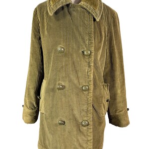 May include: A vintage olive green corduroy coat with a faux fur collar. The double-breasted coat features large, round buttons and two front pockets. The coat is displayed on a mannequin.