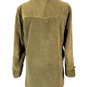 May include: A vintage olive green corduroy jacket with a faux fur collar. The jacket has a button closure, long sleeves, and a classic design. The corduroy fabric has vertical ridges. The jacket is displayed on a hanger.