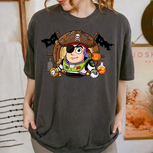 spooky pirate astronaut with eye patch on ship wheel, halloween space cowoby, trick or treat character png