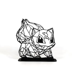 May include: A black geometric sculpture of a Bulbasaur character, a popular creature from the Pokémon franchise. The sculpture is made of interconnected lines, creating a polygonal design. It sits on a small black base.