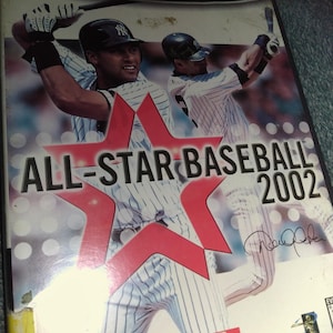 May include: Nintendo GameCube video game case for All-Star Baseball 2002. The cover features baseball players in pinstripe uniforms, with the title in large red letters. The game case has a Hollywood Video sticker.