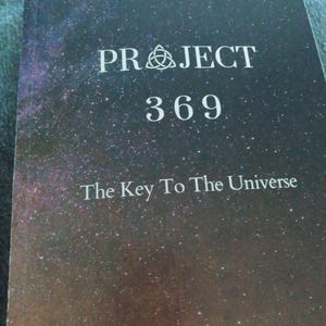 May include: A book with a dark, starry night sky cover. The title "PROJECT 369" is in white capital letters, with the subtitle "The Key To The Universe" below. A symbol is above the word "PROJECT".