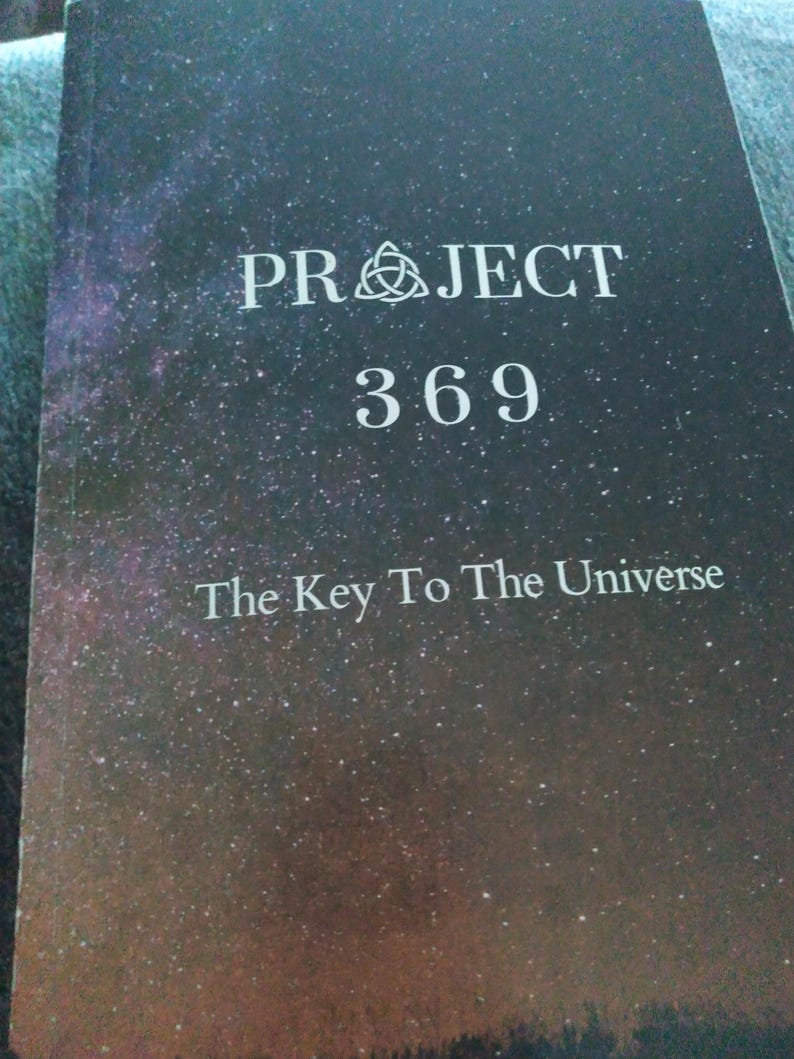May include: A book with a dark, starry night sky cover. The title "PROJECT 369" is in white capital letters, with the subtitle "The Key To The Universe" below. A symbol is above the word "PROJECT".