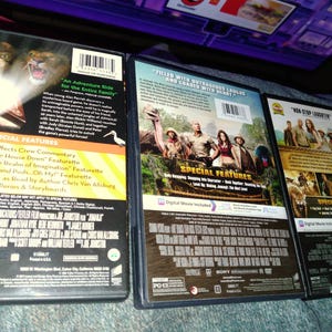 May include: Three DVD movie cases are displayed, showcasing the backs of the cases. The cases feature colorful graphics and text, with titles and special features listed. The cases are in good condition, suggesting they are well-preserved.