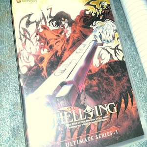 May include: A DVD case for the anime series Hellsing: Ultimate Series: I. The cover art features a dramatic illustration with a character in a red coat, a large sword, and the series title. The Geneon logo is in the upper left corner.