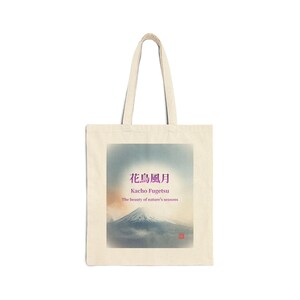 May include: A cream-colored tote bag featuring a mountain landscape design with Japanese text. The design includes a mountain peak, clouds, and text that reads "Kacho Fugetsu, The beauty of nature's seasons."