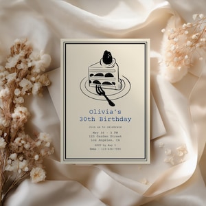 May include: A cream-colored birthday invitation with a black border features a black and white illustration of a cake slice on a plate with a fork. The text reads "Olivia's 30th Birthday".