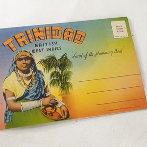 May include: Vintage postcard featuring a woman in traditional clothing holding a bowl, with the text "Trinidad, British West Indies, Land of the Humming Bird" and a place for a stamp.