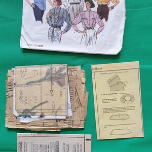 May include: A sewing pattern for a shirt with a collar and short sleeves. The pattern includes instructions in French and English. The pattern is for Vogue's Basic Design pattern number 1813.