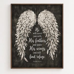 May include: A framed print featuring a pair of stylized angel wings in shades of white and gray against a dark, textured background. The text reads "He will cover you with His feathers, and under His wings you will find refuge. Psalm 91:4."