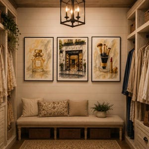 May include: Three framed wall art prints featuring watercolor illustrations of a perfume bottle, a Gucci storefront, and makeup brushes with lipstick. The prints are displayed above a long beige bench with three woven baskets underneath.