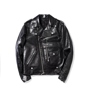 May include: A black leather jacket in a classic biker style. It features an asymmetrical zip, multiple pockets, and silver-tone hardware. The jacket has a glossy finish and a tailored fit.