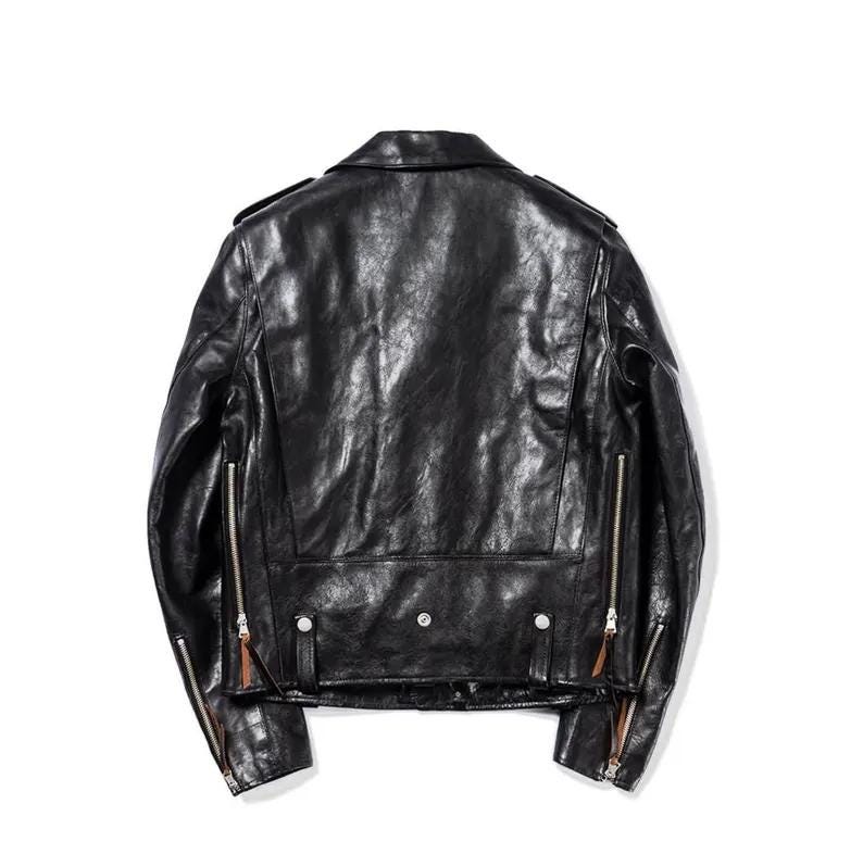 May include: Black leather jacket with a classic biker style. Features include a notched collar, asymmetrical zipper closure, multiple zippered pockets, and a belt detail at the waist. The jacket has a slightly distressed appearance.