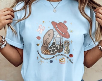 Koszulka dla fanów Taylor Swift Eras Cowboy Boot Fan, jasnoniebieska koszulka z grafiką z jajkami wielkanocnymi z trasy koncertowej Eras i motywem kowbojskich butów, spotkania i codzienne noszenie