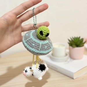 May include: A white ceramic mug with a black handle and the text "But First, Coffee" in a black, handwritten-style font. The mug is on a white surface.