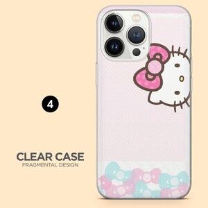 Op de afbeelding: Transparante telefoonhoes met een roze achtergrond, Hello Kitty-ontwerp en zwevende roze en blauwe strikaccenten. De tekst "CLEAR CASE FRAGMENTAL DESIGN" is zichtbaar.
