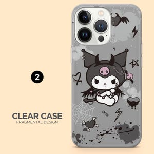May include: Clear phone case with a gray background featuring a cartoon character with a skull on its head, bat wings, and a chain. The case also has a spiderweb, hearts, and lightning bolts. The text "CLEAR CASE FRAGMENTAL DESIGN" is at the bottom.