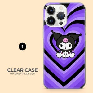 May include: A clear phone case with a purple and black heart design. The case features a cartoon character with a black hat and a pink skull. The text "CLEAR CASE FRAGMENTAL DESIGN" is visible.
