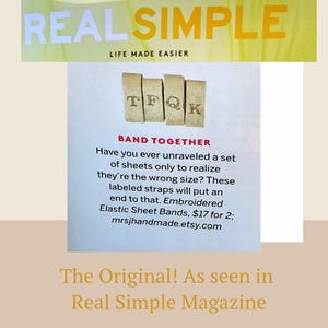 May include: A magazine page from Real Simple magazine featuring a product called "Elastic Sheet Bands" with the text "Band Together" and "Have you ever unraveled a set of sheets only to realize they're the wrong size? These labeled straps will put an end to that. Embroidered Elastic Sheet Bands, $17 for 2; mrsjhandmade.etsy.com". The image shows a close-up of the product, which is a set of four beige fabric bands with the letters "TFQK" embroidered on them.