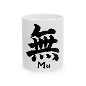May include: White ceramic mug with a black Japanese calligraphy design. The design features the character "Mu" in a bold, brushstroke style. The mug is cylindrical and has a simple, clean aesthetic.