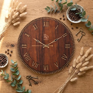 May include: A round wooden wall clock with Roman numerals and gold-colored hands. The clock has a dark brown wood grain finish and a decorative stitched border. The clock face has the text "BO Quartz". The clock is surrounded by decorative elements.