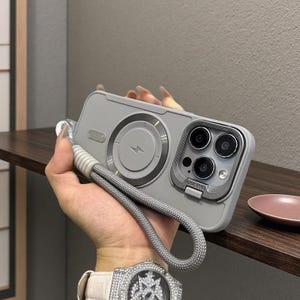 May include: A set of three ceramic mugs with a speckled, matte finish. The mugs are in shades of cream, light gray, and dark gray. Each mug has a simple, minimalist design, perfect for coffee or tea.