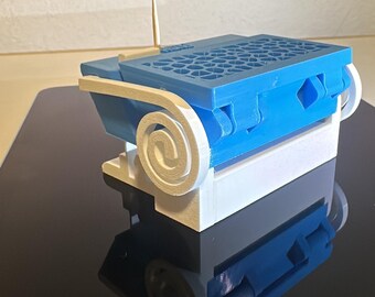 May include: A 3D-printed model of a blue and white architectural structure with a wooden toothpick. The model features a blue top with a lattice design, white scrollwork, and a white base. The model is sitting on a black surface.