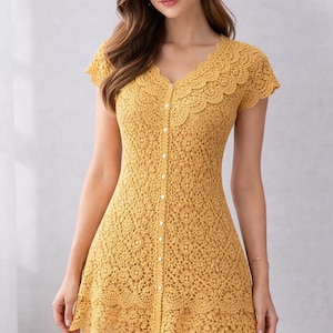 May include: Mustard yellow crochet dress with a V-neckline and short sleeves. The dress features a button-down front and a scalloped edge along the neckline and hem. The crochet pattern is intricate and detailed, creating a textured look.