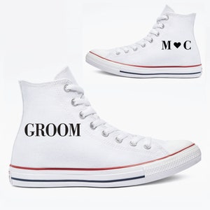 May include: A pair of white high-top sneakers with black text. One shoe says "Groom" and the other says "M♥C".