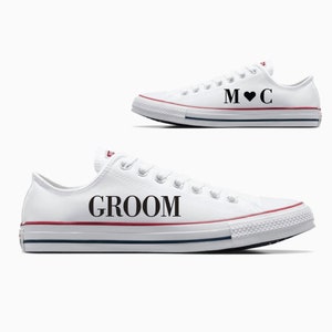 May include: A pair of white canvas sneakers with black text. One shoe says "Groom" and the other says "M ♥ C".