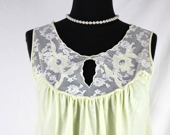 May include: A pale yellow sleeveless nightgown with white lace trim and a keyhole neckline. The lace features delicate floral designs.