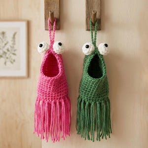 May include: A set of three ceramic mugs with a speckled, matte finish. The mugs are in shades of cream, light gray, and dark gray. Each mug has a simple, minimalist design, perfect for coffee or tea.