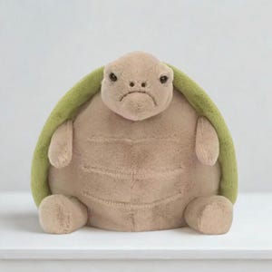 May include: A set of three ceramic mugs with a speckled, matte finish. The mugs are in shades of cream, light brown, and dark brown. Each mug has a simple, minimalist design, perfect for coffee or tea.