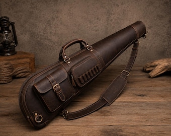 May include: A dark brown leather carrying case with a tapered shape, featuring a top handle, an adjustable shoulder strap, a buckled front pocket, and a smaller side pocket with multiple loops for small items, all secured with brass-toned hardware.