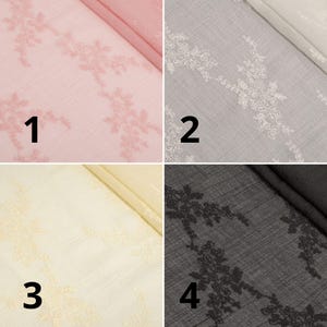 May include: Four fabric swatches in pink, grey, cream, and black, each with a floral lace design. The fabrics are folded, showing the texture and colour variations. The swatches are numbered 1 to 4.