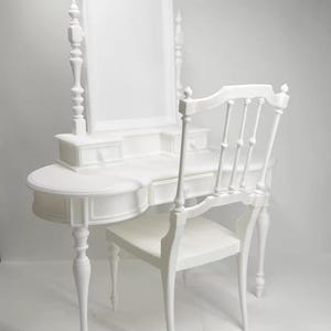 May include: A white vanity set with a matching chair. The vanity has an arched mirror, drawers, and a curved tabletop. The chair has a slatted back and curved legs. The set is all white.