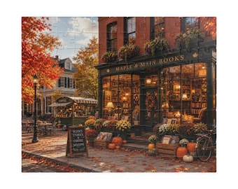 May include: A jigsaw puzzle depicting a bookstore named Maple & Main Books with a brick facade, large windows, and autumn decor including pumpkins and flowers. A sidewalk sign reads Books Stories Coffee Welcome, with a coffee cart nearby.