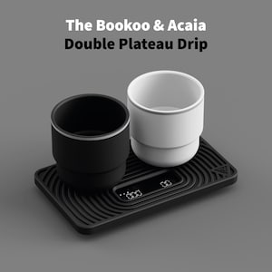 May include: A black and white double plateau drip set with the text "The Bookoo & Acaia Double Plateau Drip". The set includes a black cup, a white cup, and a black tray with a digital display.