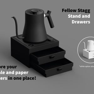 May include: Black Fellow Stagg kettle with a gooseneck spout, atop a black stand with two drawers. Text reads "Store your scale and paper filters in one place!" and "Fellow Stagg Stand and Drawers."
