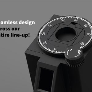 May include: A black device with a circular dial featuring white markings and a knob. The dial has numbers from 0 to 90. The text "Seamless design across our entire line-up!" is visible.