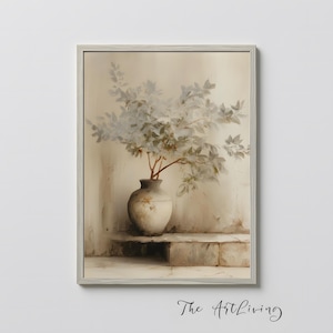 Puede incluir: Una impresión enmarcada que presenta un bodegón de un jarrón con ramas frondosas. El jarrón es de color beige claro y se encuentra sobre una repisa de piedra. El fondo es de un beige neutro con una textura sutil. La obra está firmada "The Art Living".