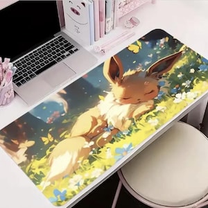 May include: A rectangular mousepad featuring a sleeping cartoon character with large ears, lying in a field of flowers. The design incorporates shades of yellow, green, and blue, with a laptop and desk accessories visible in the background.