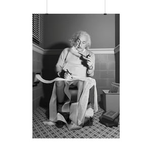May include: A black and white photographic print featuring Albert Einstein sitting on a toilet, holding a pipe in one hand and a pen in the other, while writing on a long, continuous roll of paper that extends from a wall-mounted dispenser.