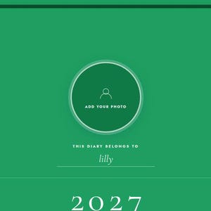 May include: Green diary cover with a circular photo placeholder and the text "ADD YOUR PHOTO." Below, it reads "THIS DIARY BELONGS TO lilly" and the year "2027" is displayed at the bottom. The design is simple and modern.