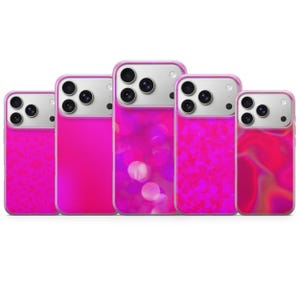 May include: Five smartphone cases arranged in a row, each featuring a distinct shade of vibrant pink. The designs include a leopard print, a solid hot pink, a circular bokeh pattern, a textured pink glitter effect, and a swirling pink liquid design.