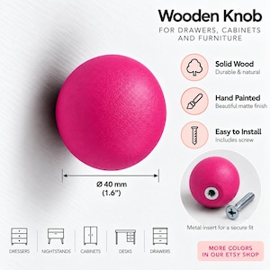May include: A round, hot pink wooden knob for furniture with a 1.6-inch diameter. The text reads Wooden Knob for drawers, cabinets and furniture, Solid Wood, Hand Painted, Easy to Install, and Metal insert for a secure fit. Icons show furniture types.